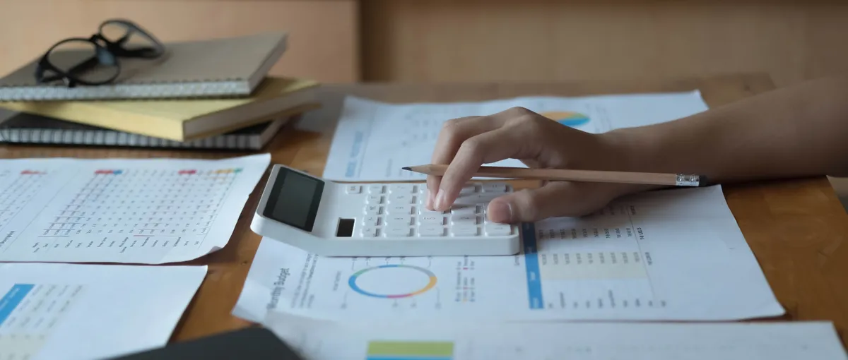 Calculator and rate sheet on an investor's desk